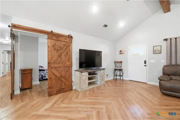 a bedroom with furniture and a flat screen tv