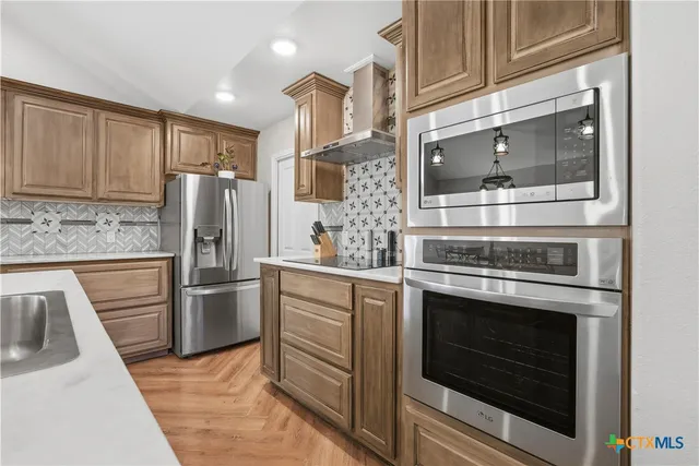 a kitchen with a stove microwave and refrigerator