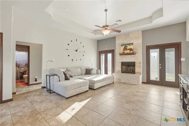 a living room with furniture a dining table and a fireplace