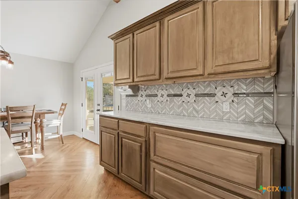 a kitchen with stainless steel appliances granite countertop a sink and cabinets