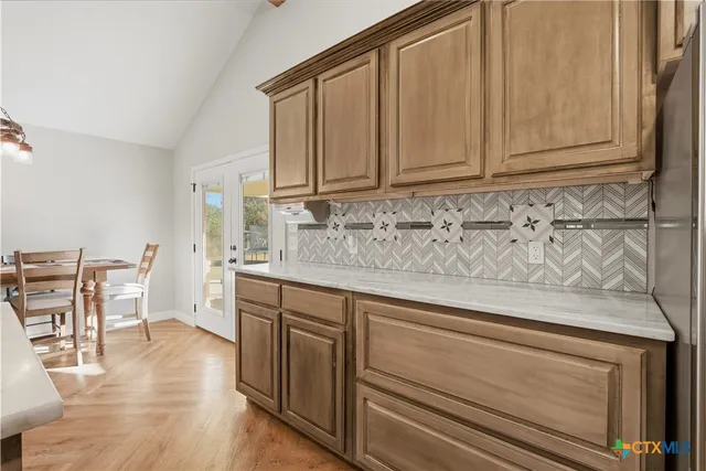 a kitchen with stainless steel appliances granite countertop a sink and cabinets