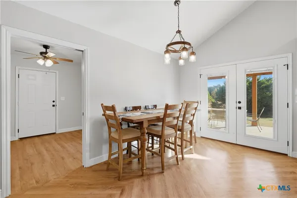 a view of a dining room with furniture wooden floor and chandelier