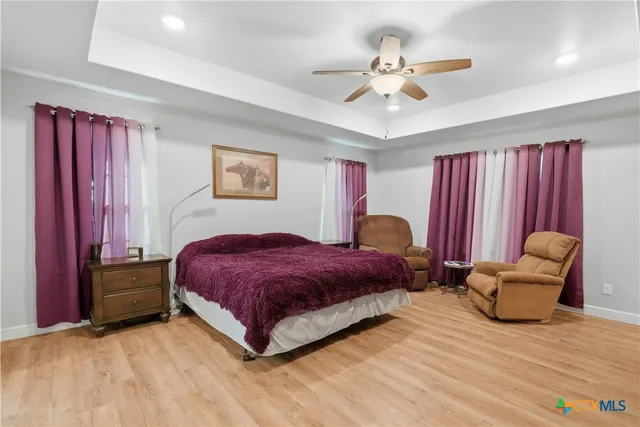 a spacious bedroom with a bed and a chair