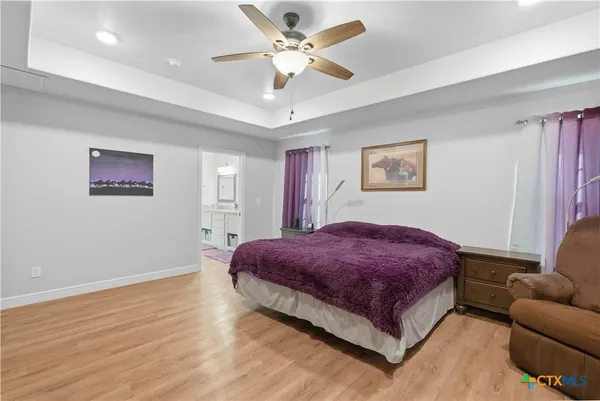 a spacious bedroom with a bed and a couch