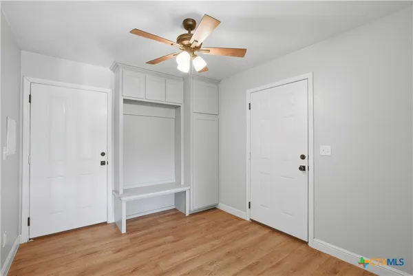 a view of an empty room with wooden floor