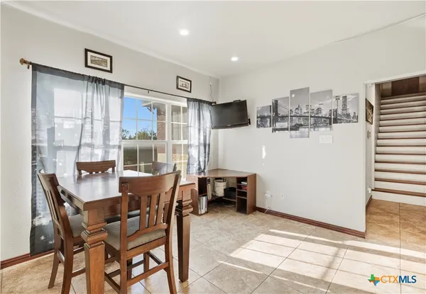 a dining room with furniture and window