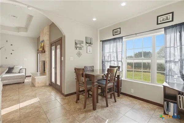a view of a dining room with furniture and a window