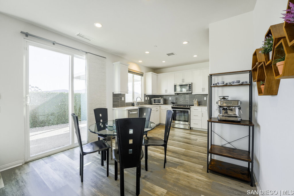 8615 Chaparral Way Santee, CA 92071 - Photo 12 of 46 a view of a dining room with furniture and wooden floor