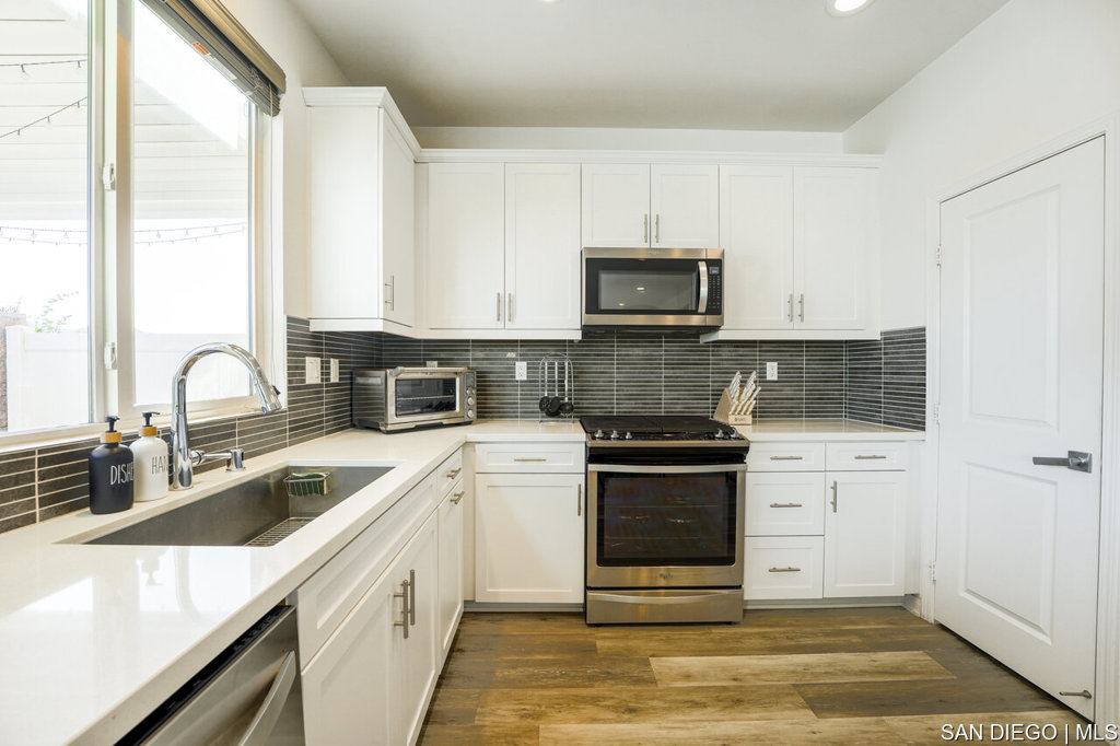 8615 Chaparral Way Santee, CA 92071 - Photo 14 of 46 a kitchen with a sink stove and microwave