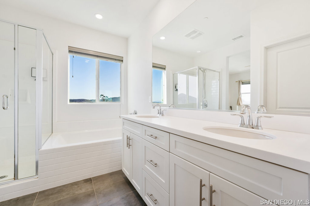 8615 Chaparral Way Santee, CA 92071 - Photo 24 of 46 a bathroom with a tub sink and mirror
