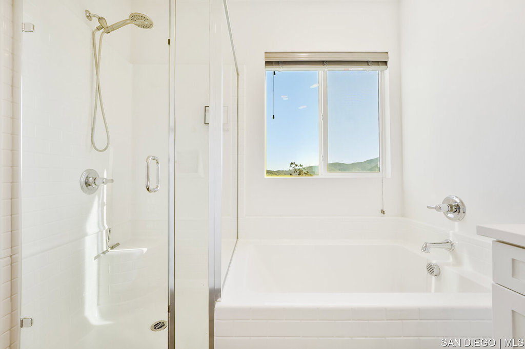 8615 Chaparral Way Santee, CA 92071 - Photo 25 of 46 a bathroom with a bathtub and shower