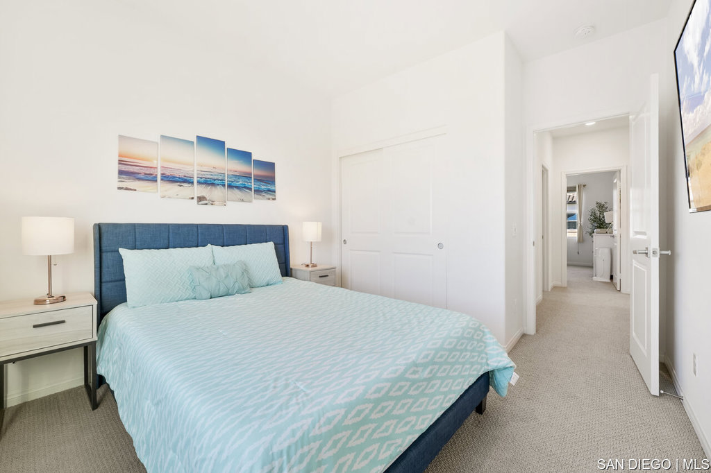 8615 Chaparral Way Santee, CA 92071 - Photo 27 of 46 a bedroom with a bed and a lamp