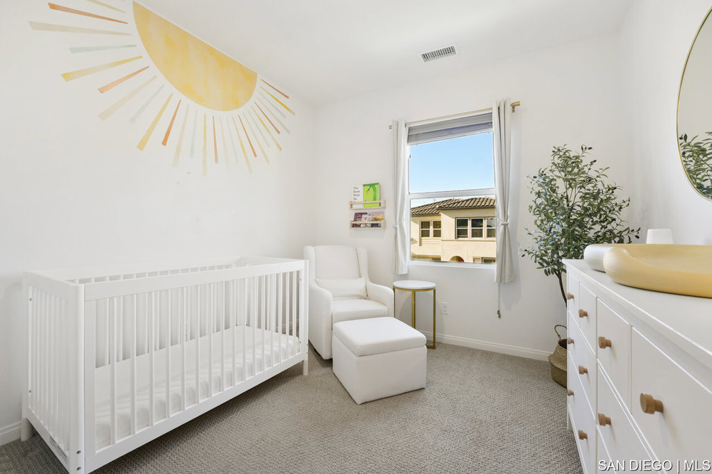 8615 Chaparral Way Santee, CA 92071 - Photo 29 of 46 a living room with furniture and a baby crib