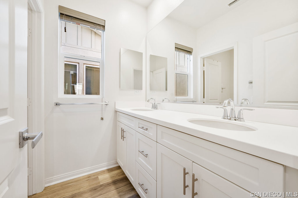 8615 Chaparral Way Santee, CA 92071 - Photo 30 of 46 a bathroom with a double vanity sink a mirror and a