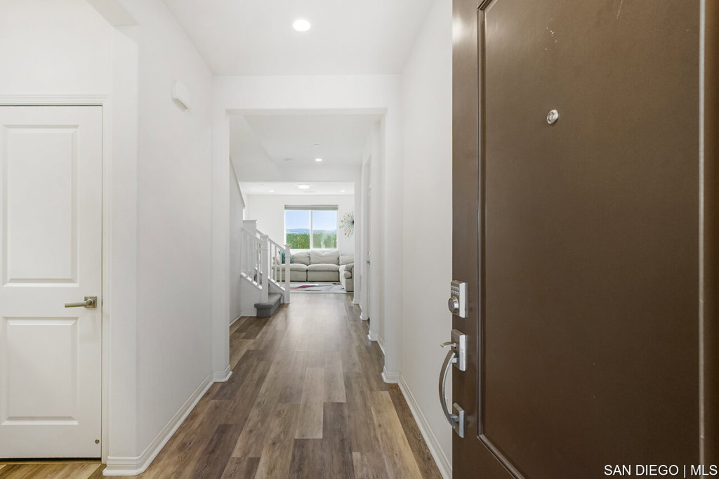 8615 Chaparral Way Santee, CA 92071 - Photo 5 of 46 a view of a hallway with wooden floor and a bathroom