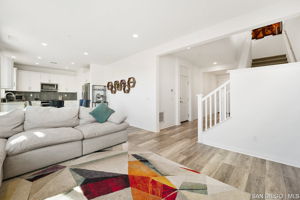 8615 Chaparral Way Santee, CA 92071 - Photo 9 of 46 a living room with furniture and kitchen view with wooden floor