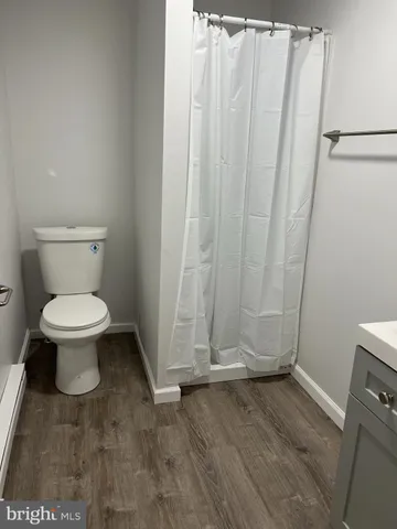 a bathroom with a toilet and a shower