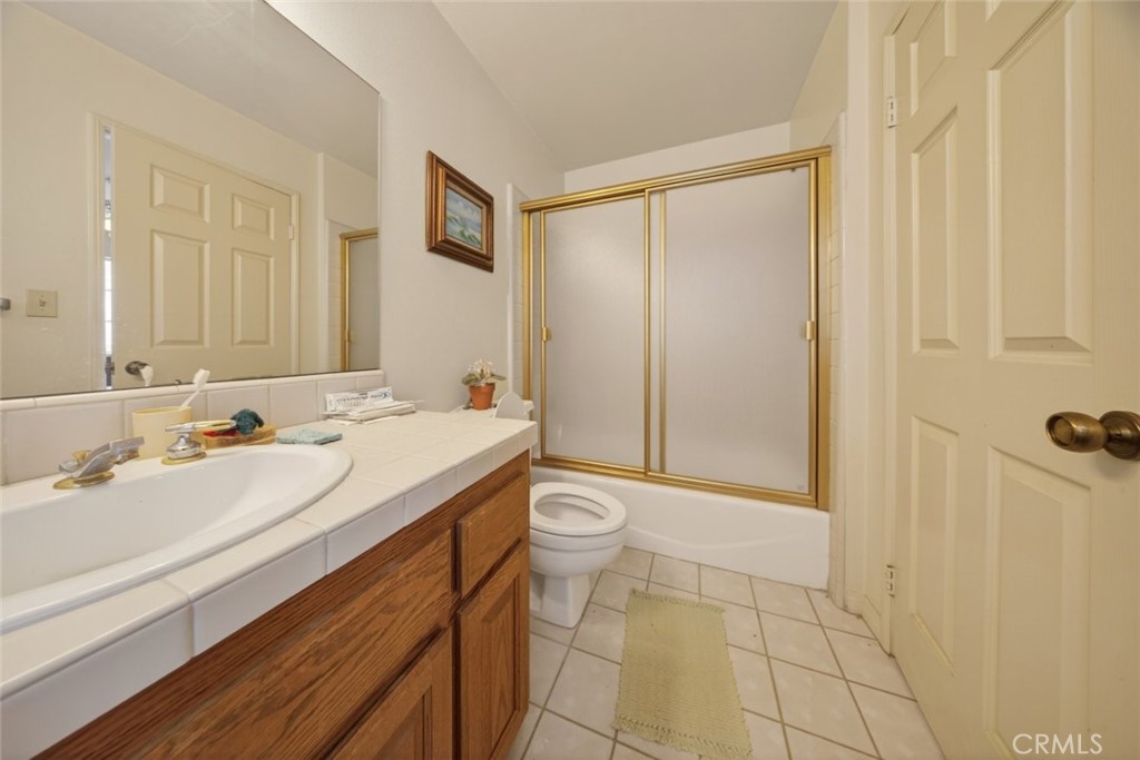 1978 Starvale Road Glendale, CA 91207 - Photo 31 of 75 a bathroom with a granite countertop sink a toilet and shower