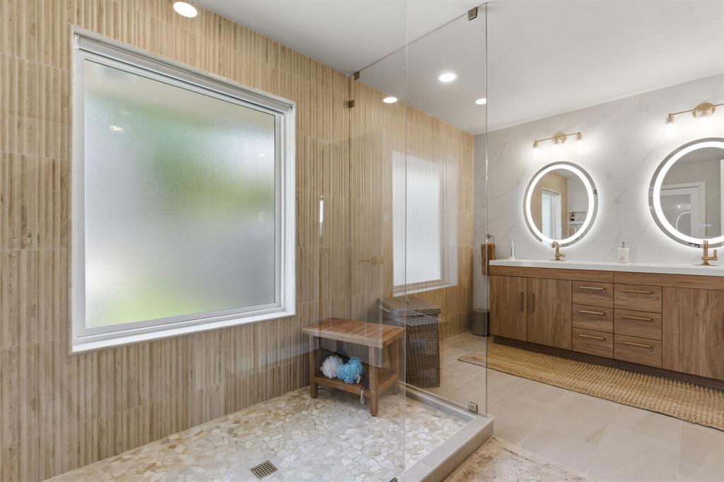10390 Ridgecrest Street Frisco, TX 75033 - Photo 27 of 40 a spacious bathroom with a mirror a sink and a mirror