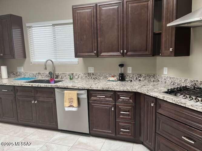 11553 East Tanque Verde Road Tucson, AZ 85749 - Photo 13 of 16 a kitchen with granite countertop stainless steel appliances white cabinets sink and dishwasher