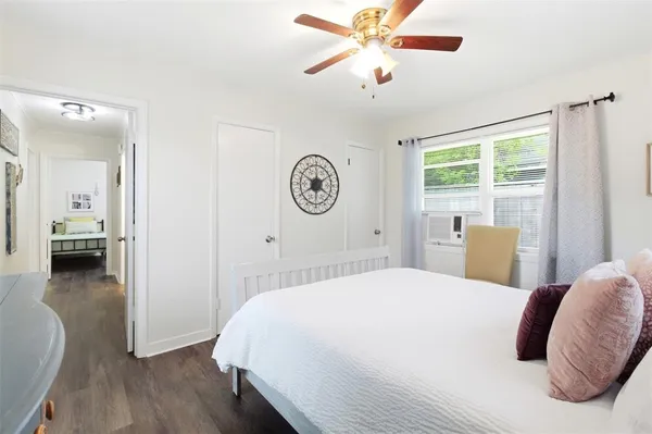 a spacious bedroom with a bed and a chandelier