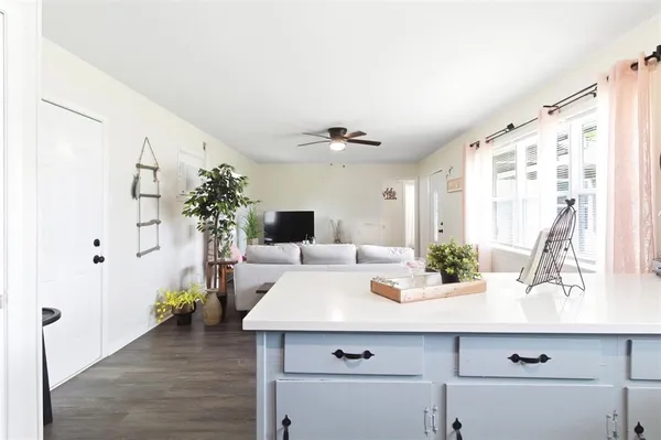 a view of living room with furniture and potted plants