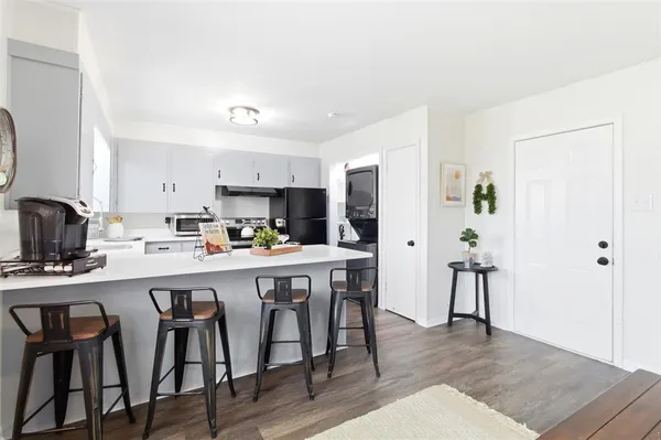 a kitchen with a table and chairs in it