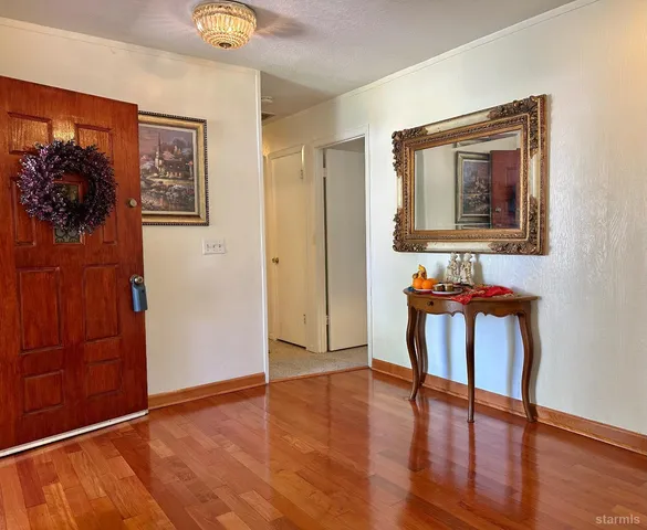 a view of a livingroom with furniture and entryway