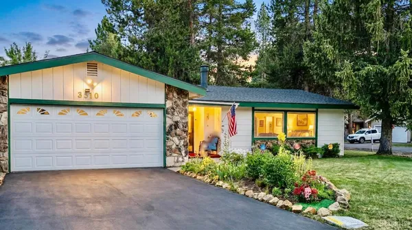 a view of a house with a garage and a yard