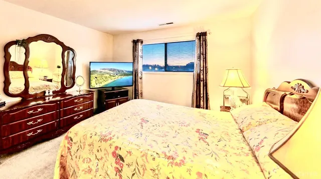 a bedroom with a bed and a dresser