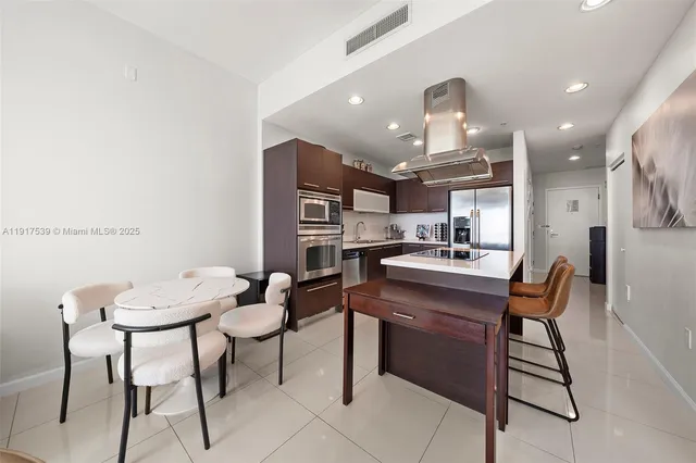 a kitchen with a dining table chairs and view kitchen