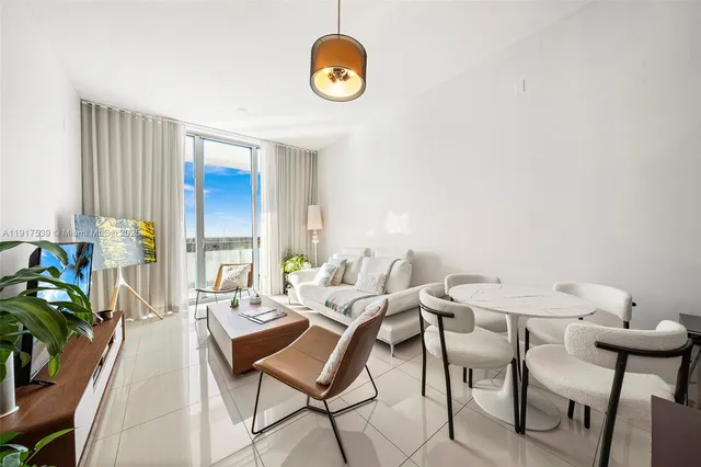 a view of a dining room with furniture and a window