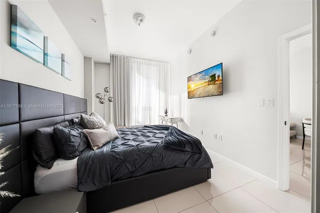 a bedroom with a bed and a painting on the wall