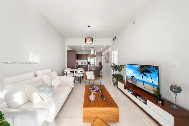 a living room with furniture gym equipment and a rug