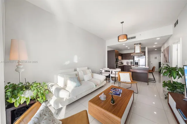 a living room with furniture and a potted plant