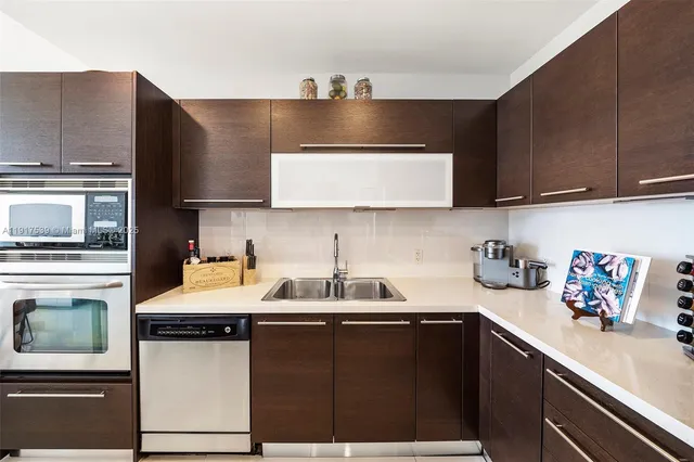 a kitchen with a sink and a stove top oven