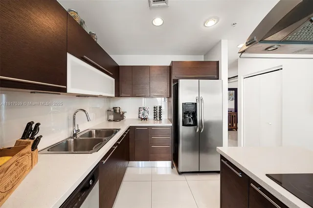 a kitchen with a refrigerator sink and stainless steel appliances