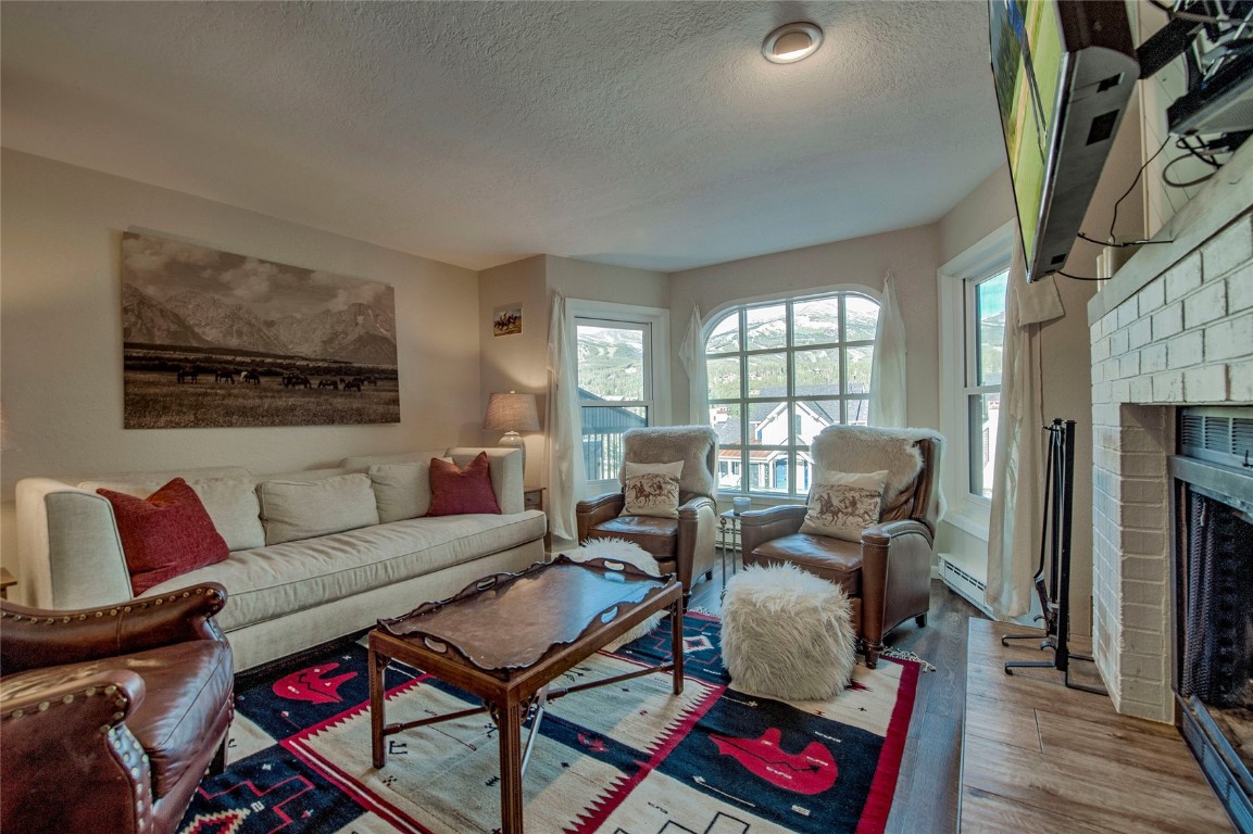 a living room with furniture fireplace and a window