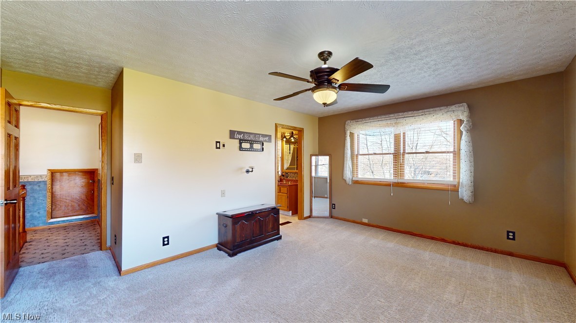6755 State Rte 5 Ravenna, OH 44266 - Photo 20 of 34 Carpeted bedroom featuring ceiling fan and a textured ceiling