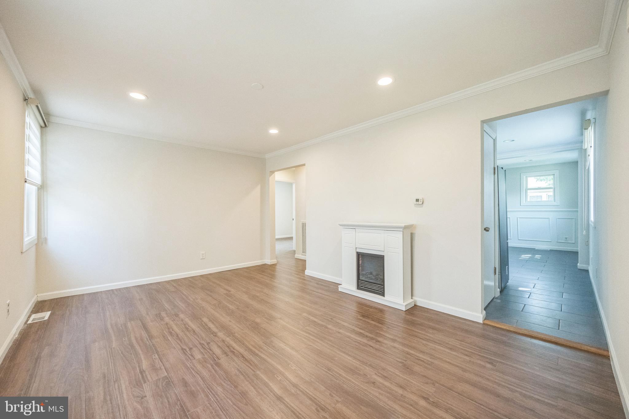 76 Edison Road Cherry Hill, NJ 08034 - Photo 13 of 29 an empty room with wooden floor fireplace and windows