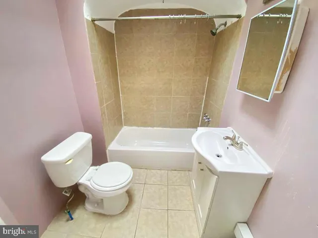 a bathroom with a toilet sink and shower