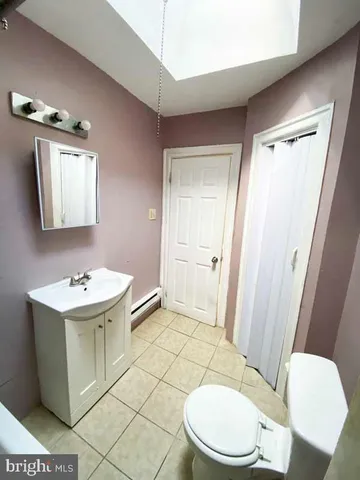 a bathroom with a sink a toilet a mirror and vanity