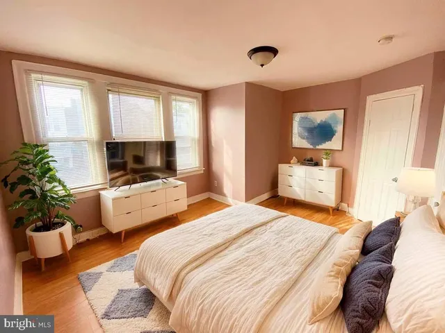 a bedroom with two beds and a potted plant