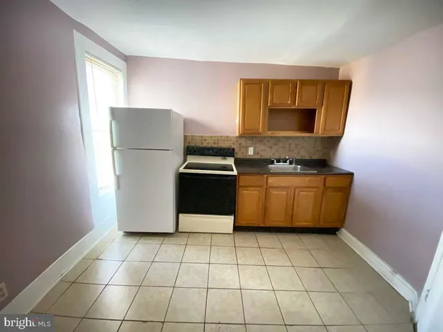 a kitchen with stainless steel appliances a refrigerator sink and microwave