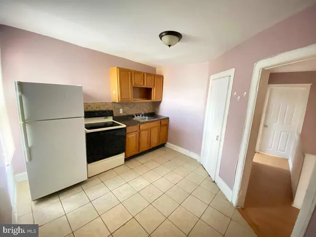 a kitchen with stainless steel appliances a refrigerator and a stove