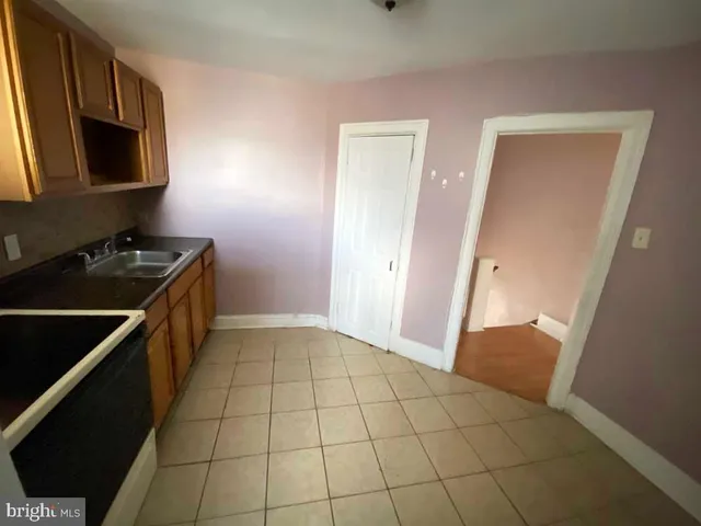 a kitchen with a sink a stove and a microwave