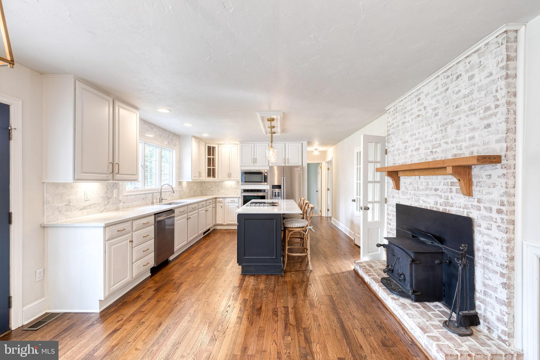 1216 Bonaire Road Forest Hill, MD 21050 - Photo 17 of 71 a large kitchen with cabinets wooden floor and stainless steel appliances