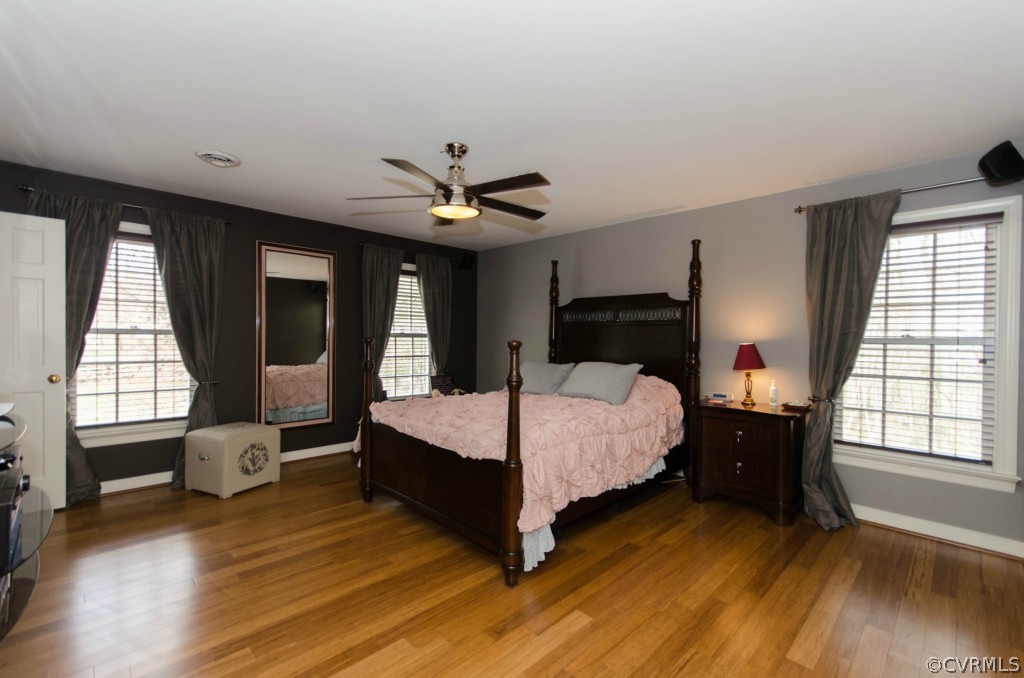 2209 Kings Lynn Road Midlothian, VA 23113 - Photo 15 of 24 a bedroom with a bed window and wooden floor