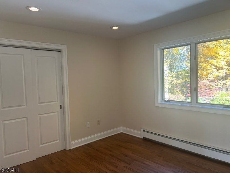 102 Drakestown Road Hackettstown, NJ 07840 - Photo 18 of 28 a view of an empty room with wooden floor and a window