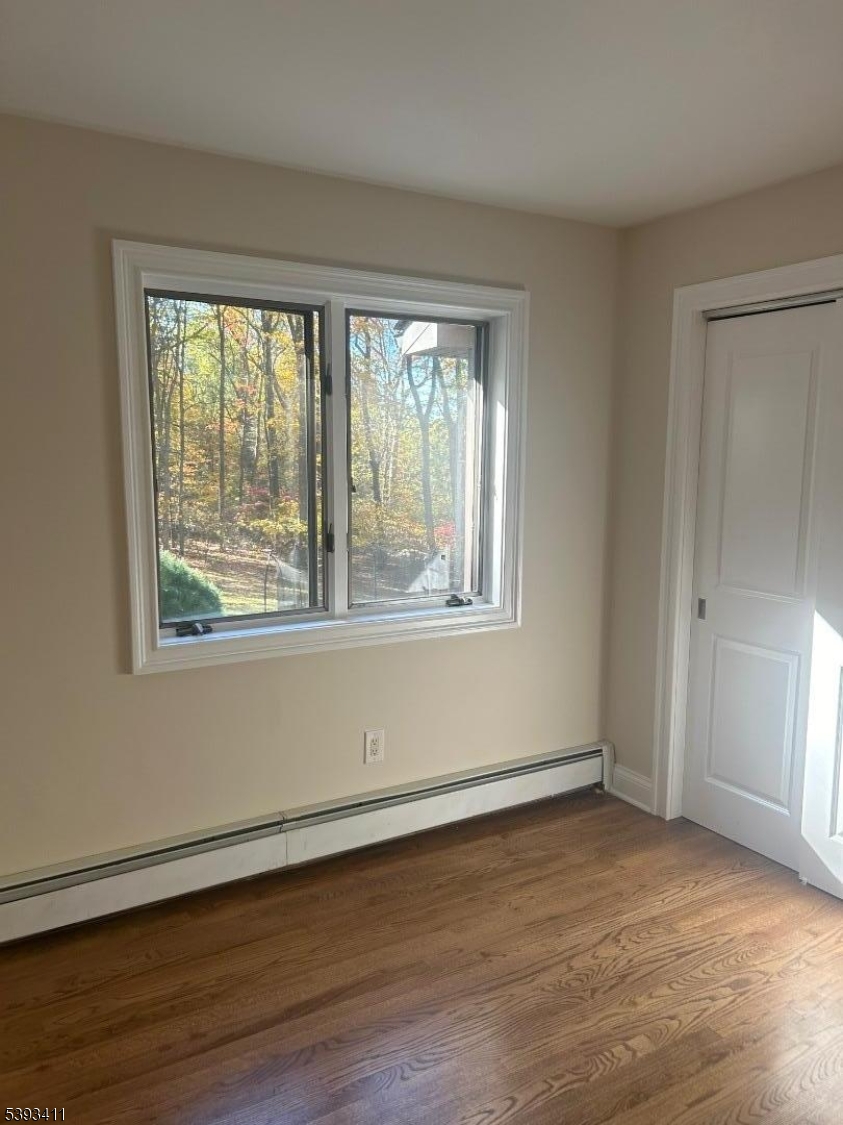 102 Drakestown Road Hackettstown, NJ 07840 - Photo 22 of 28 a view of an empty room with wooden floor and a window